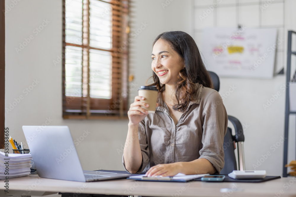 Happy indian girl asian woman drinking hot coffee in workplace an home office. Happy indian girl asian woman drinking hot coffee in workplace an home office.