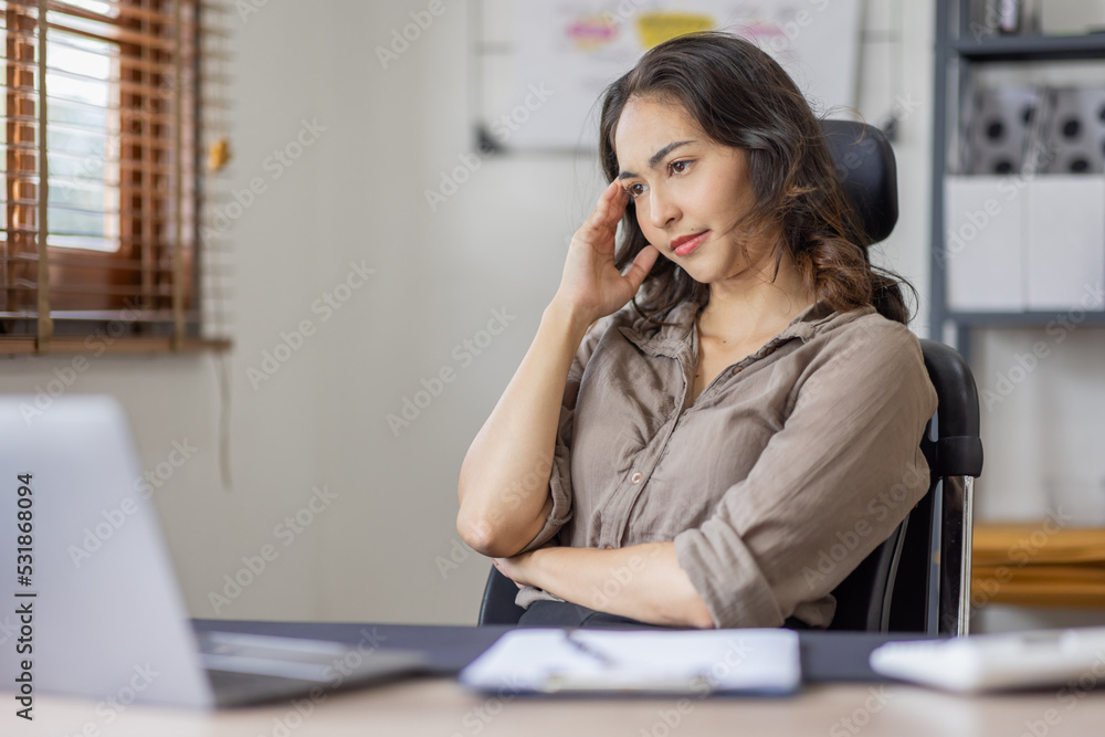 Asian indian women are stressed while working on laptop, Tired asian businesswoman with headache at office, feeling sick at work copy space in workplace an home office. Asian indian women are stressed while working on laptop, Tired asian businesswoman with headache at office, feeling sick at work copy space in workplace an home office.