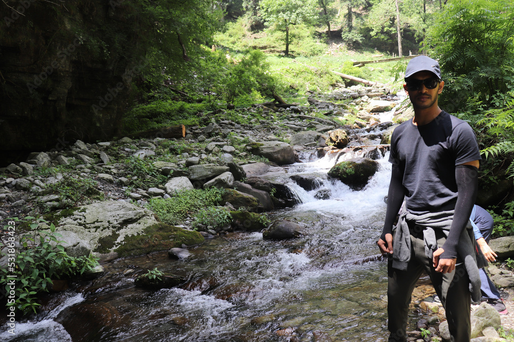 A person standing against cascades in river A person standing against cascades in river