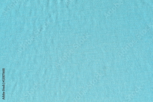 The texture of soft knitted cotton fabric is blue. An old tattered napkin.