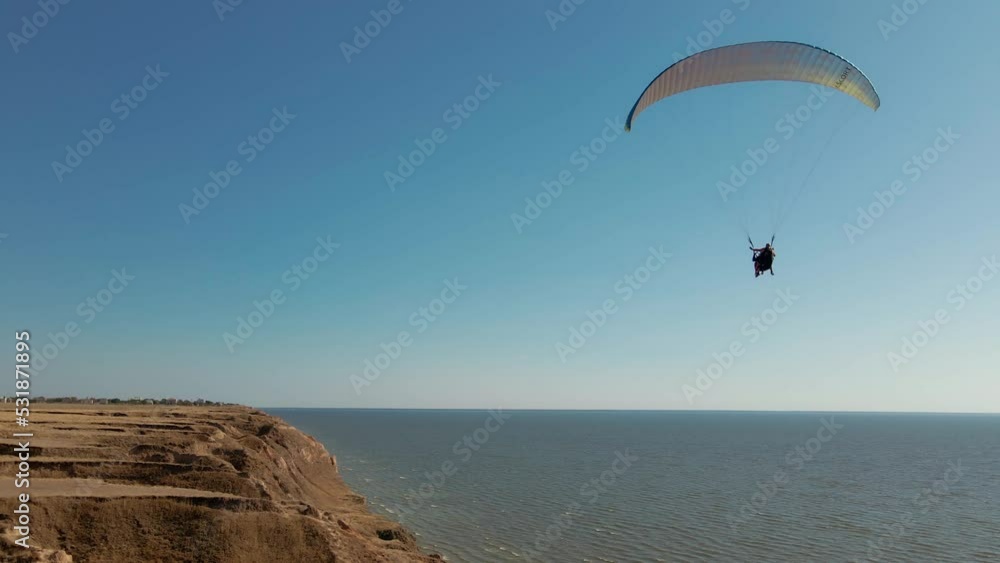 aerial view slow motion filming of active leisure with paragliding, active lifestyle extreme sport concept. Ukraine, Kherson region, Stanislav aerial view slow motion filming of active leisure with paragliding, active lifestyle extreme sport concept. Ukraine, Kherson region, Stanislav