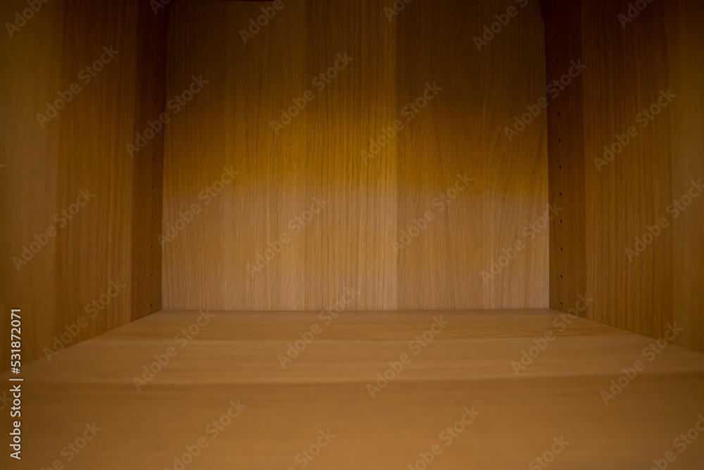 The display in the room decorated with wooden surfaces has empty spaces and shadows. The display in the room decorated with wooden surfaces has empty spaces and shadows.