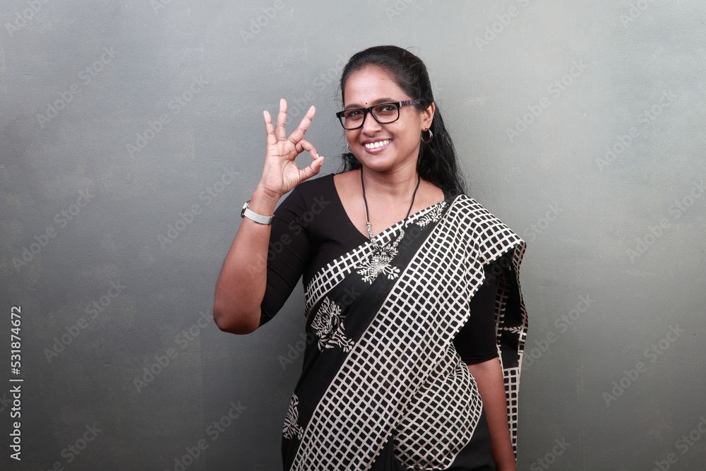 Portrait of a happy woman of Indian ethnicity showing 'like'gesture