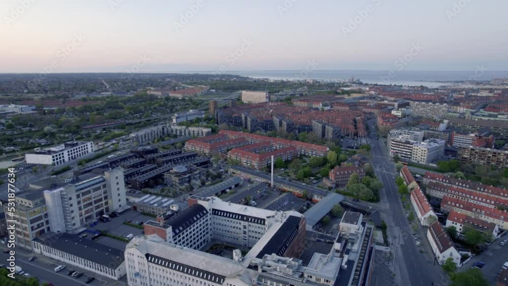 Drone camera tilts down over small building with Drone camera tilts down over small building with
