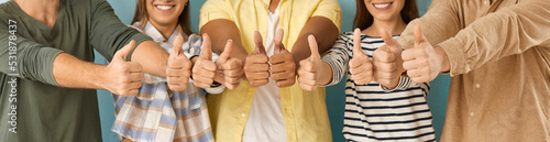 Fotografiet Diverse group of happy cheerful young people showing thumbs up