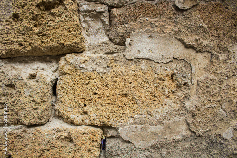 Fototapeta premium evocative textured image of a wall of old tuff bricks