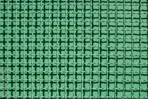 evocative texture image of a green gate grate