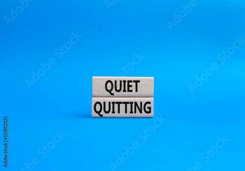 Quiet quitting symbol. Concept word Quiet quitting on wooden blocks. Beautiful blue background. Business and Quiet quitting concept. Copy space.