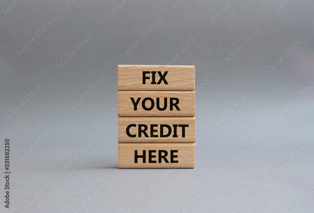 Fix your credit here symbol. Concept words Fix your credit here on wooden blocks. Beautiful grey background. Business and Fix your credit here concept. Copy space. Fix your credit here symbol. Concept words Fix your credit here on wooden blocks. Beautiful grey background. Business and Fix your credit here concept. Copy space.