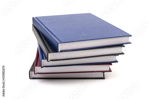 Stacked hardcover notebooks on white background. Education business concept.