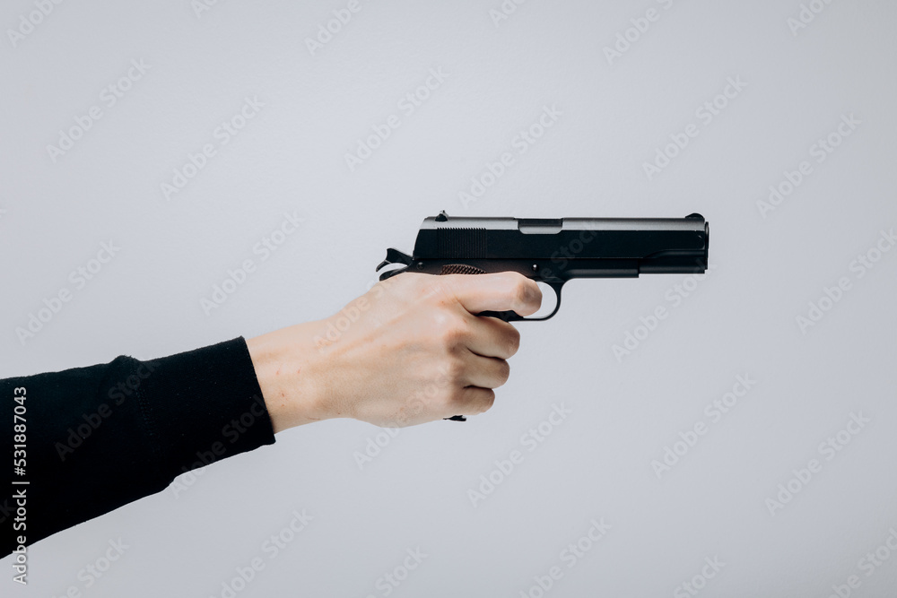Close up of man hand with aiming gun on white background. Close up of man hand with aiming gun on white background.