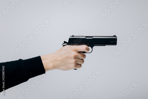 Close up of man hand with aiming gun on white background.