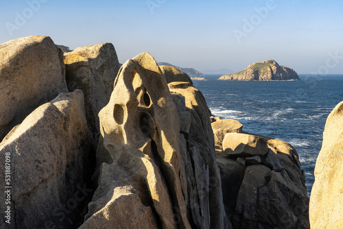 Acantilados de papel (Paper cliffs) in the Rías Altas zone in Gaiicia at sunset with sinuous rock formations. photo