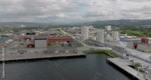 Industrial area with warehouses and factories on harbor, Verdal, Norway; drone photo