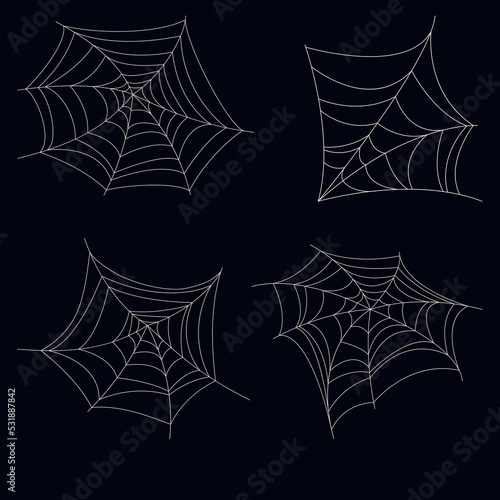set of four lace spider webs on dark background