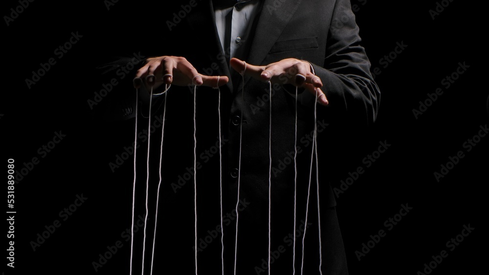Man hands with strings on fingers on black background. Violence, harassment, bullying concept. Master in business suit, abuser using influence to control person behavior. Manipulation of government. Man hands with strings on fingers on black background. Violence, harassment, bullying concept. Master in business suit, abuser using influence to control person behavior. Manipulation of government.
