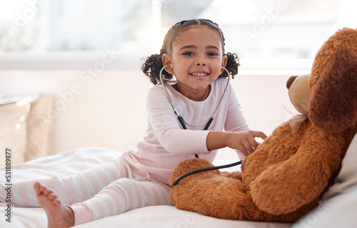 Photos Children, stethoscope and teddy bear with a girl playing doctor in her bedroom at home with a stuffed animal