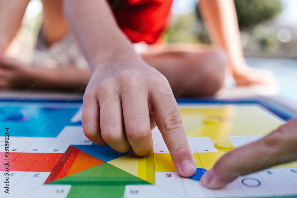 a child's finger moves a board game token a child's finger moves a board game token