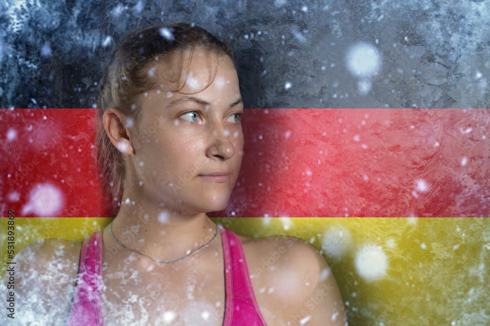 Obraz premium Young woman on frozen background with flag of Germany. Concept of crisis in Europe in winter. Energy crisis.
