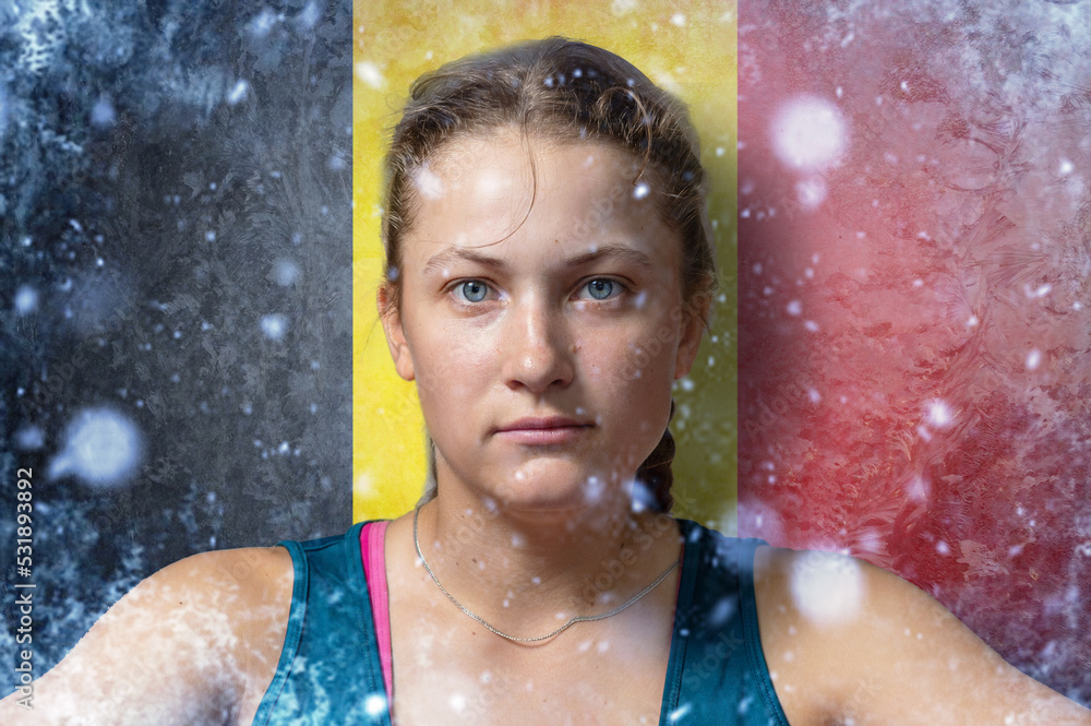 Obraz premium Young woman on frozen background with flag of Belgium. Concept of crisis in Europe in winter. Energy crisis.