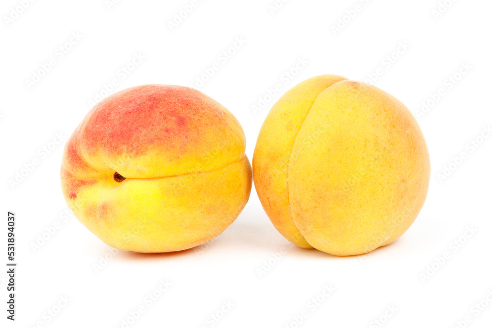 Two ripe peaches on a white background, close-up. Two ripe peaches on a white background, close-up.