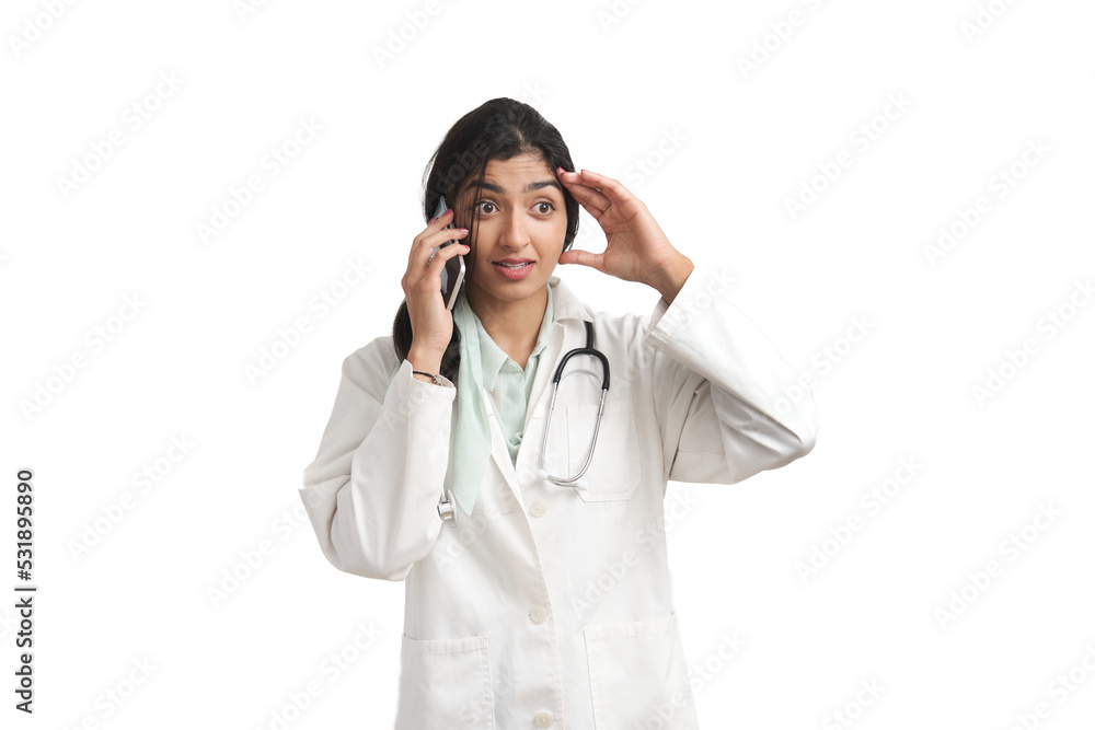 Young Venezuelan female doctor surprised talking on the smartphone. Isolated over white background. Young Venezuelan female doctor surprised talking on the smartphone. Isolated over white background.