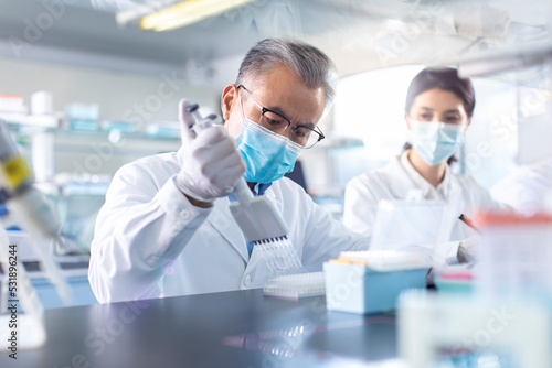 Scientists examining medical sample in laboratory