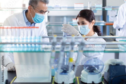 Scientists examining medical sample in laboratory photo