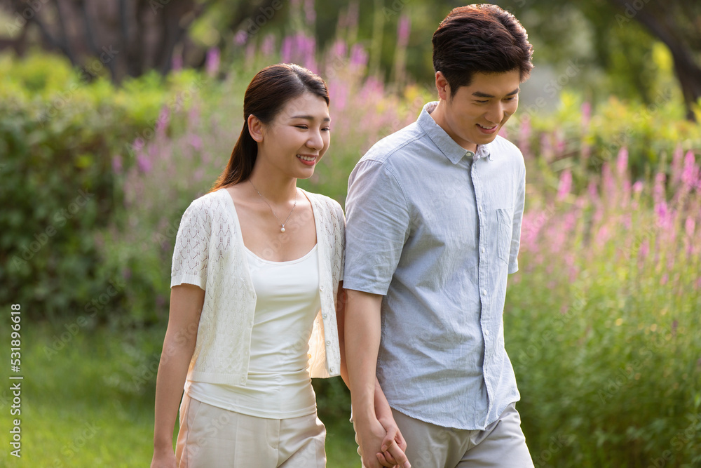 Happy young couple relaxing in park Happy young couple relaxing in park