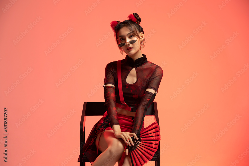Beautiful young woman holding a fan Beautiful young woman holding a fan