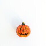 Colourful halloween pumpkin on white background with copy space. Minimal autumn fall holidays concept