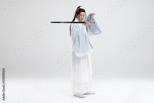 Young swordsman in ancient costume photo