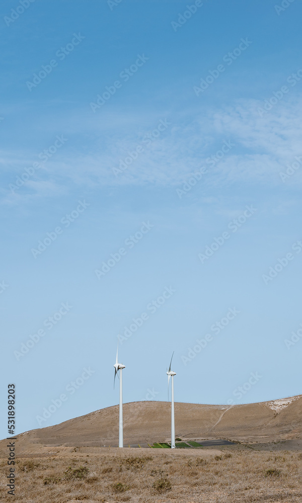 wind turbines next to some fields