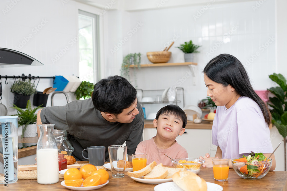 Happy asian family enjoy having breakfast or lunch together in the kitchen. little boy fun eating food with father, mother. asia family spend time activity at home. warm relationship in house Happy asian family enjoy having breakfast or lunch together in the kitchen. little boy fun eating food with father, mother. asia family spend time activity at home. warm relationship in house