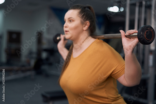 Caucasian woman with overweight weightlifting at the gym
