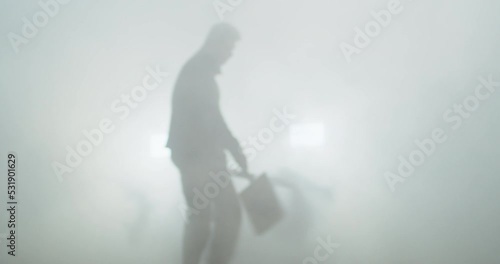 A visual effects specialist creates a dense fog with a foghorn before filming.