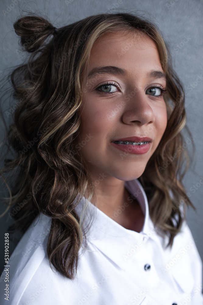 Portrait of beautiful girl teenage with light make-up.The gitl is smiling in braces Portrait of beautiful girl teenage with light make-up.The gitl is smiling in braces