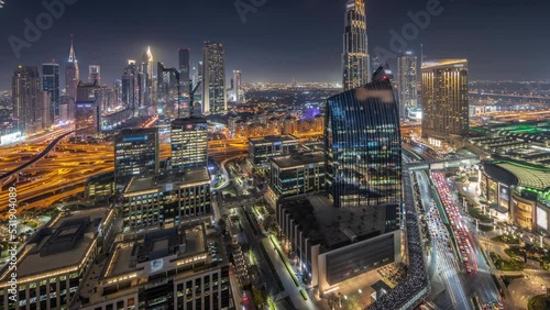 Wallpaper Mural Futuristic Dubai Downtown and financial district skyline panorama aerial day to night transition timelapse. Many illuminated towers and skyscrapers with traffic on streets Torontodigital.ca