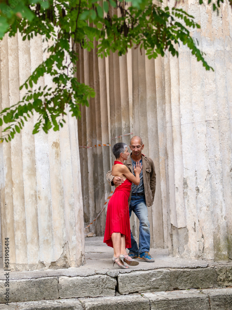 Tango nuevo dance - the famous partner dance with a woman in a red dress with the vibrant & playful style of movement, rich expressions, improvisation and close connection and passion between dancers