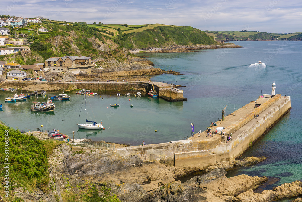 Aerial view of the boats, piers and outer harbour in Mevagissey, Cornwall. The image was shot from the viewpoint which overlooks the town and sticks out from the top of nearby cliffs.