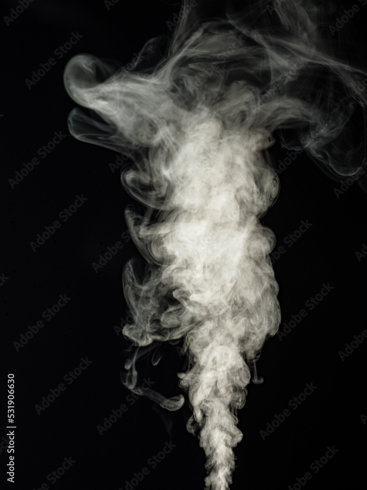 Fluffy white smoke on a black background, swirls and rises upwards as an abstract effect Fluffy white smoke on a black background, swirls and rises upwards as an abstract effect