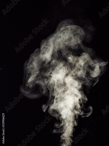Fotografie White smoke on a black background, rising in balls as an abstract effect