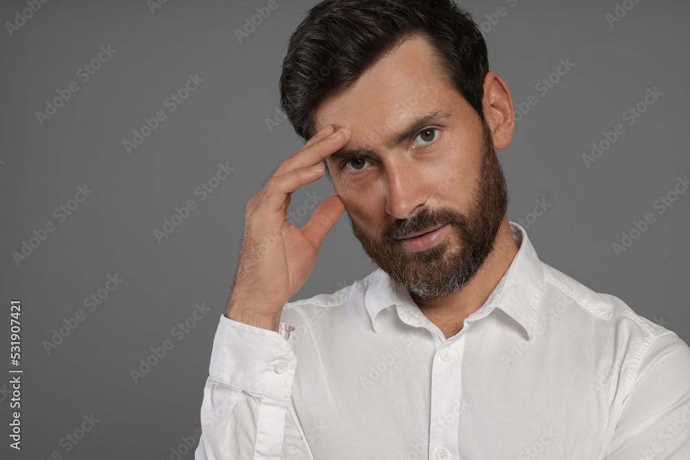 Portrait of handsome bearded man on grey background, space for text Portrait of handsome bearded man on grey background, space for text