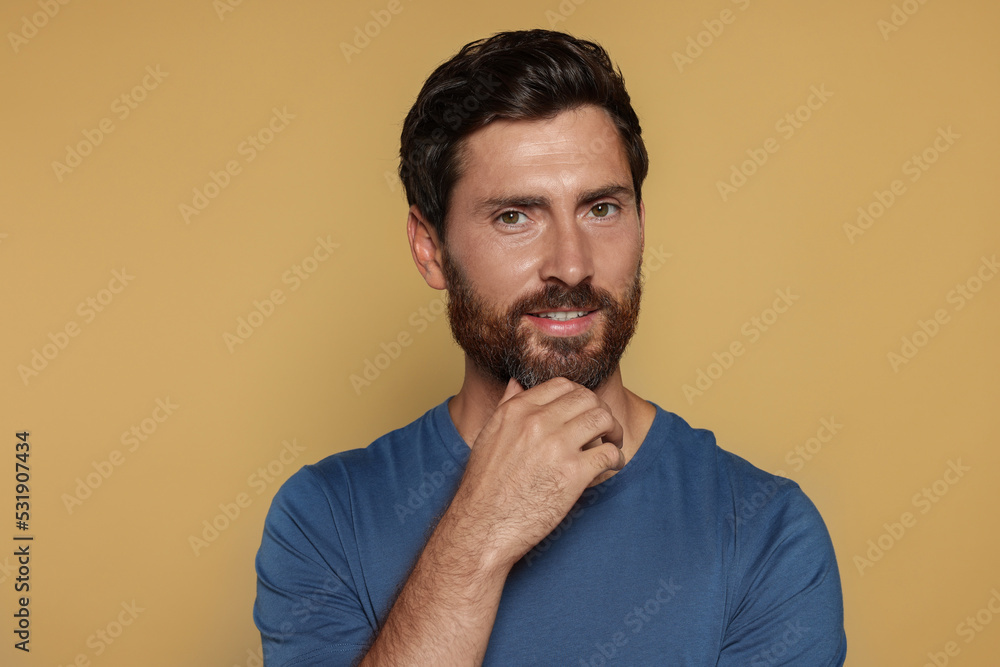 Portrait of handsome bearded man on yellow background Portrait of handsome bearded man on yellow background
