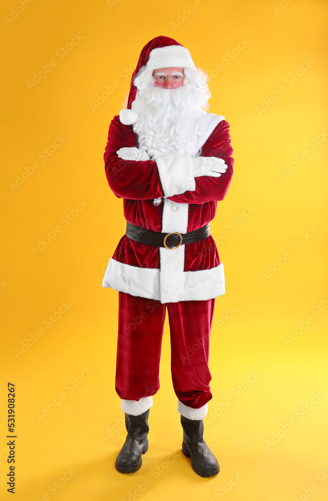 Full length portrait of Santa Claus on yellow background Full length portrait of Santa Claus on yellow background