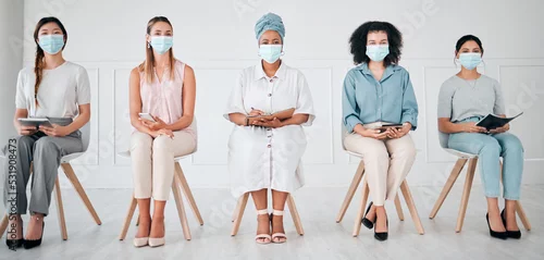 Obraz Compliance, recruitment and covid laws with business women waiting for an interview at corporate office. Hiring, corona and social distance with diverse group practice safety at company together