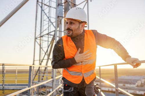 A frightened height works worker feeling nauseous from height.