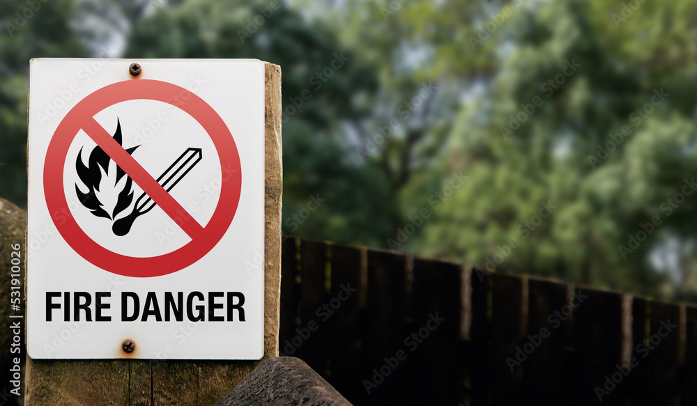 A keep out sign on a countryside tourist trail showing that it is forbidden to light any kind of fire. Prohibition to light fires in public places fire risk. A keep out sign on a countryside tourist trail showing that it is forbidden to light any kind of fire. Prohibition to light fires in public places fire risk.