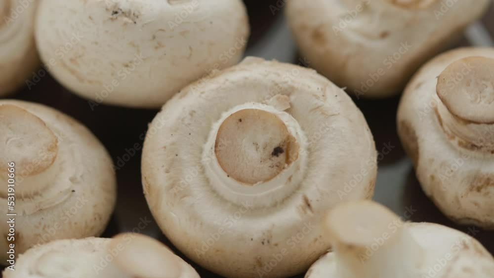 white mushrooms rotate in a circle on a plate