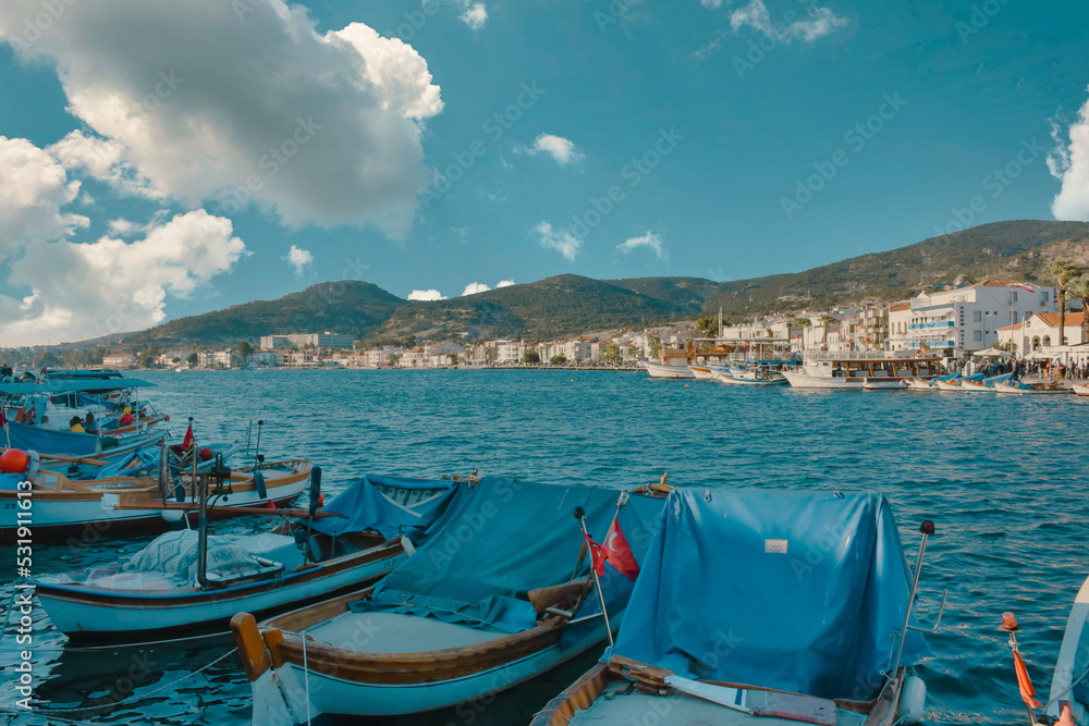 Boats along the coastline of resort town of Foca. Foca, Turkey - August 2022
